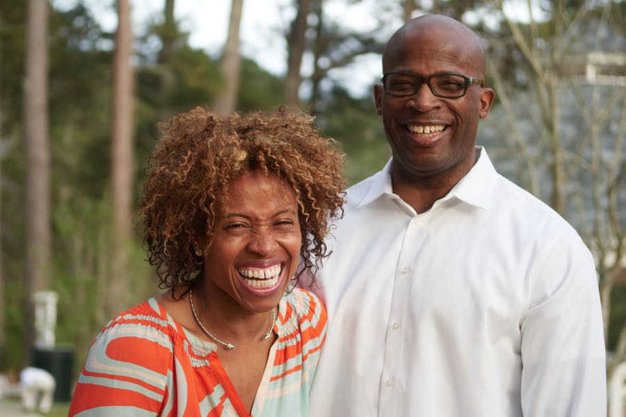 The mother laughing wide, the father beside her.