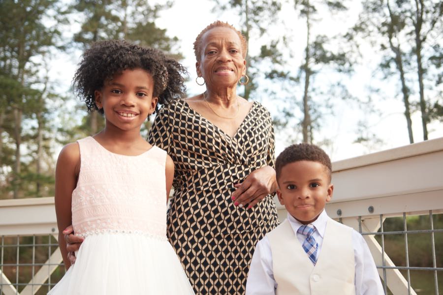 Three generations of the family standing together.