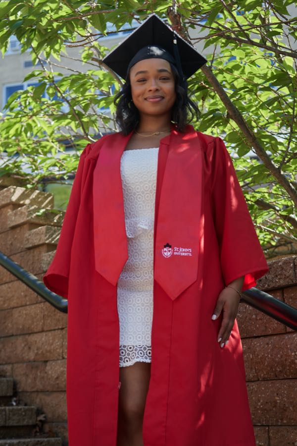 Portrait in cap and gown, looking to camera.