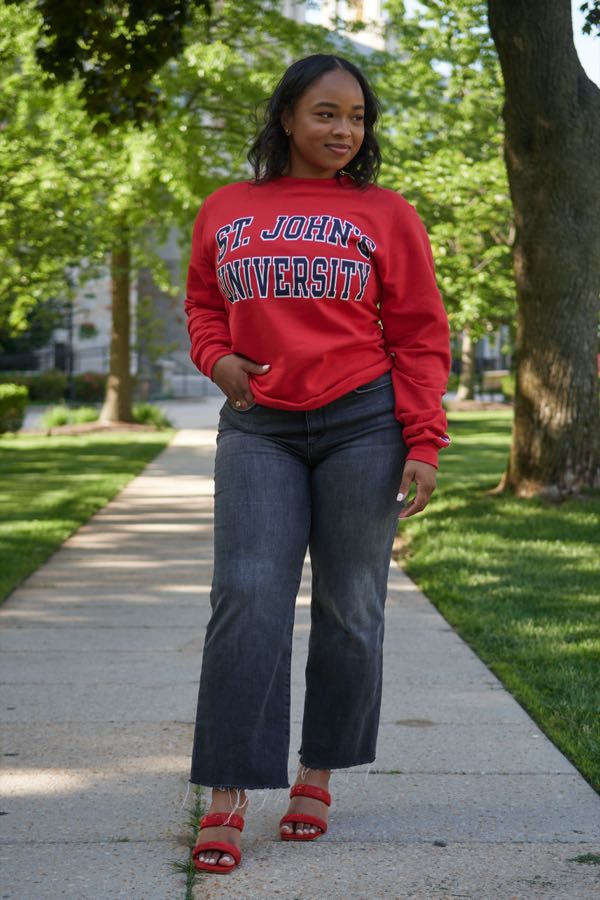 Walking the campus path in the university sweatshirt.
